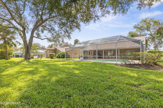 74 Kingsley Ln, Ormond Beach, FL 32174 - view of green lawn with an outdoor pool and glass enclosure