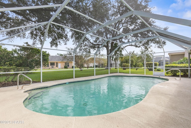 view of pool featuring glass enclosure, a patio area, and a yard