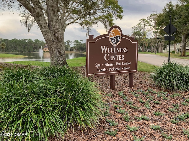 community / neighborhood sign with a water view