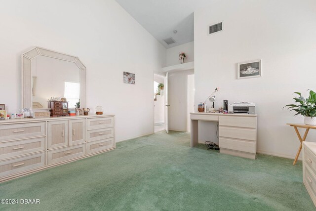 interior space with high vaulted ceiling and light colored carpet