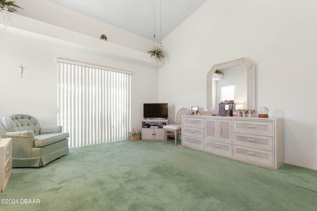 living area with high vaulted ceiling and carpet