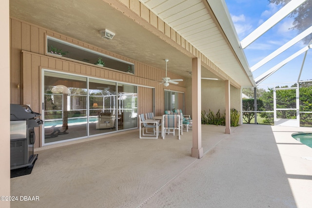 view of patio / terrace with glass enclosure, area for grilling, and ceiling fan