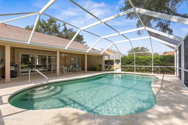 view of pool featuring grilling area, glass enclosure, ceiling fan, and a patio area