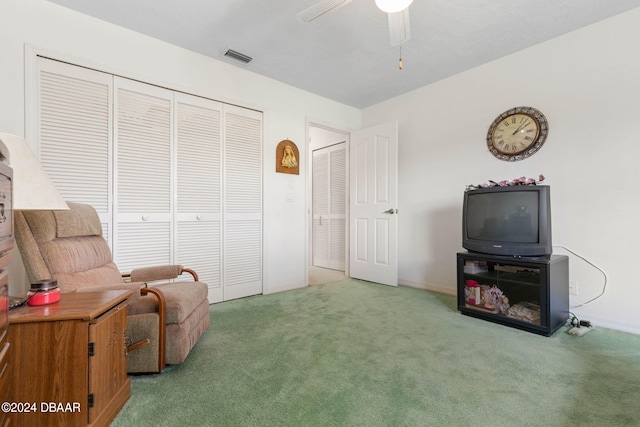 sitting room with carpet and ceiling fan