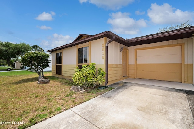 2816 Nordman Ave, New Smyrna Beach, FL 32168 - view of front of home featuring driveway, a front lawn, and an attached garage