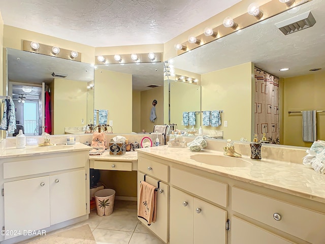 bathroom featuring vanity, a textured ceiling, tile patterned flooring, and ceiling fan