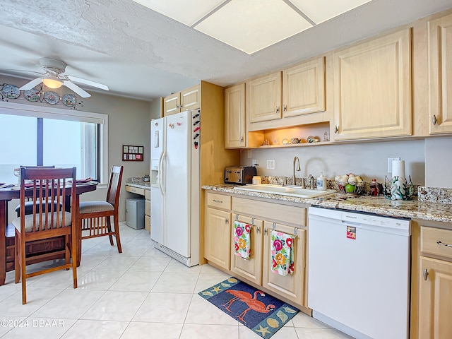 kitchen with light brown cabinets, sink, white appliances, and light tile patterned floors