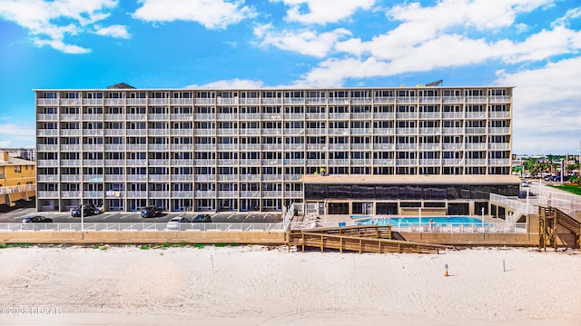 view of building exterior featuring a community pool