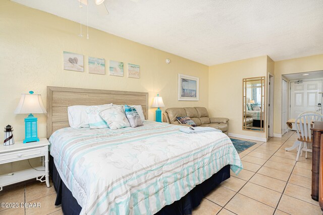 bedroom featuring light tile patterned flooring, a textured ceiling, and ceiling fan