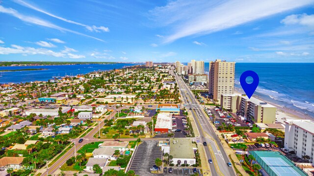 drone / aerial view featuring a water view and a view of the beach