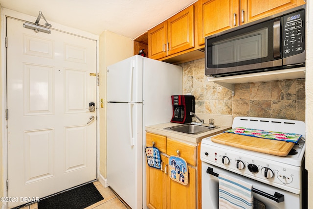 kitchen with backsplash, white appliances, sink, and light tile patterned floors