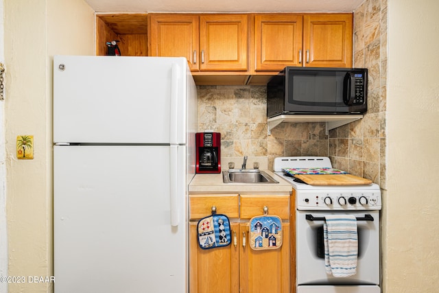 kitchen featuring sink, white appliances, and backsplash