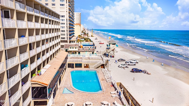 view of pool with a beach view and a water view