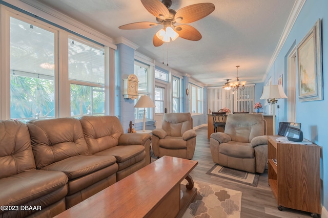 living room featuring ceiling fan with notable chandelier, ornamental molding, and light hardwood / wood-style flooring