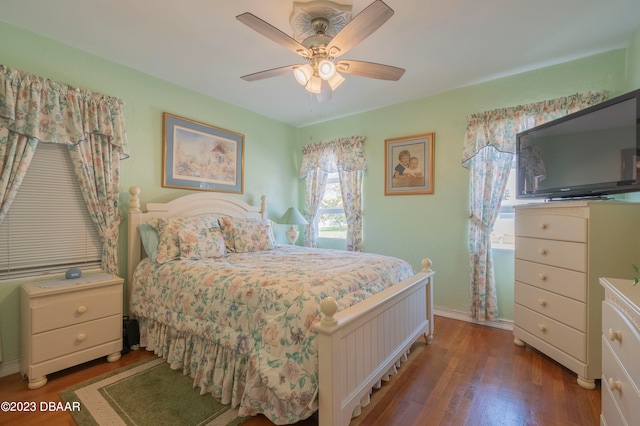 bedroom with ceiling fan and dark hardwood / wood-style floors