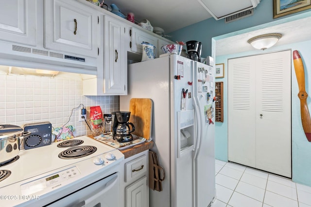 1415 Ocean Shore Blvd Unit 808, Ormond Beach, FL 32176 - kitchen with white appliances, under cabinet range hood, tasteful backsplash, light tile patterned floors, and white cabinetry