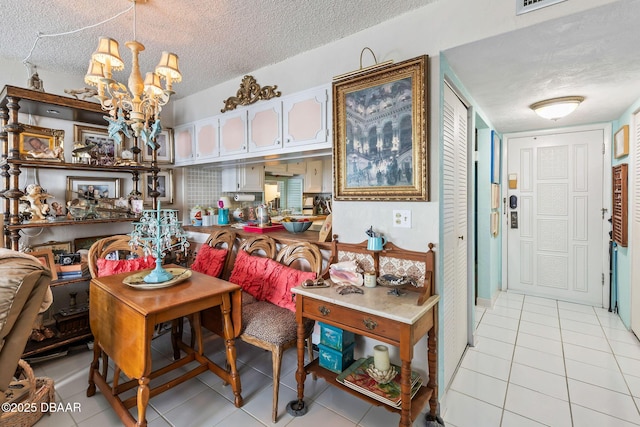 1415 Ocean Shore Blvd Unit 808, Ormond Beach, FL 32176 - dining space featuring a textured ceiling, light tile patterned flooring, and a chandelier