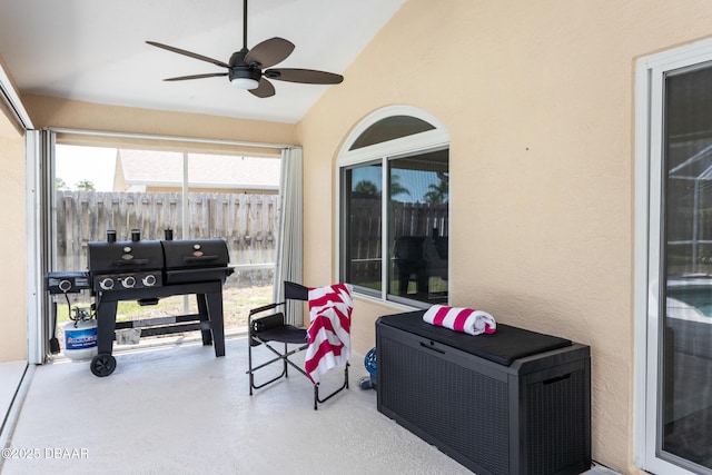 sunroom / solarium with ceiling fan and lofted ceiling