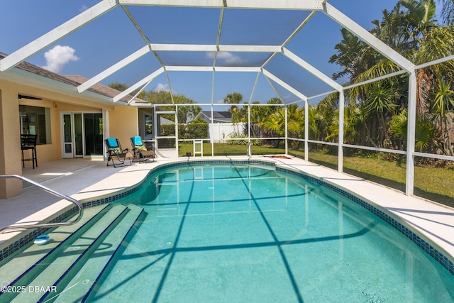 view of pool with a lanai and a patio area