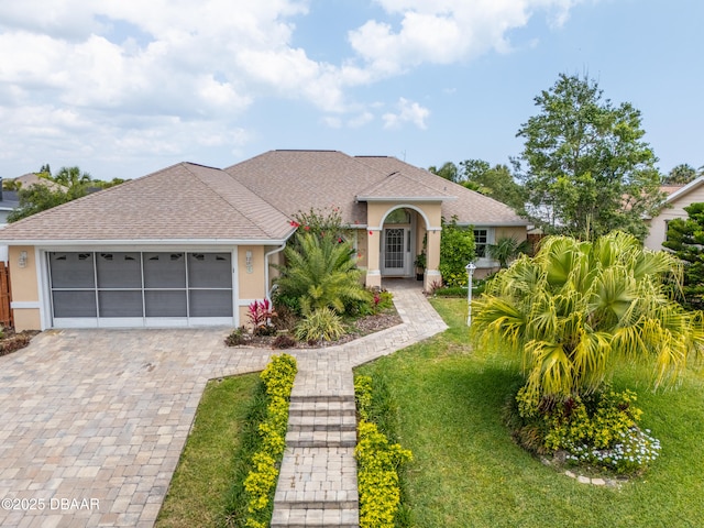 mediterranean / spanish-style home with a garage and a front yard