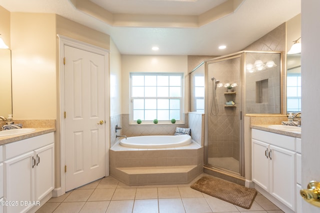 bathroom with vanity, tile patterned floors, plus walk in shower, and a raised ceiling