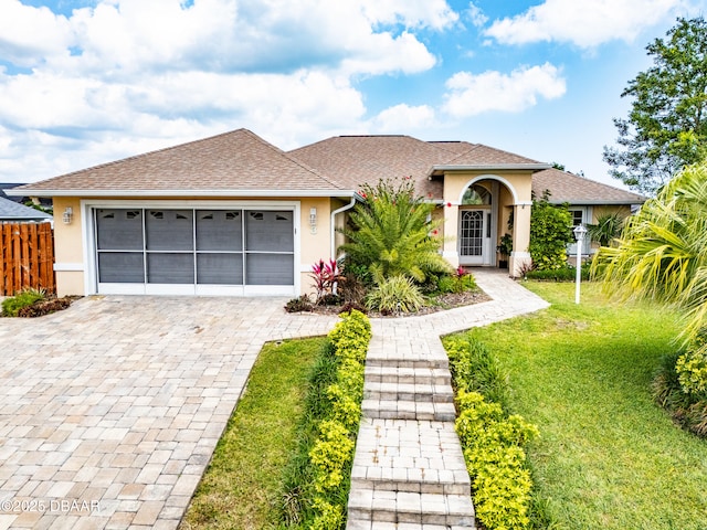 view of front of home featuring a garage and a front lawn