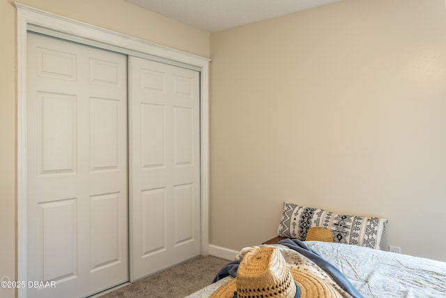 carpeted bedroom featuring a closet