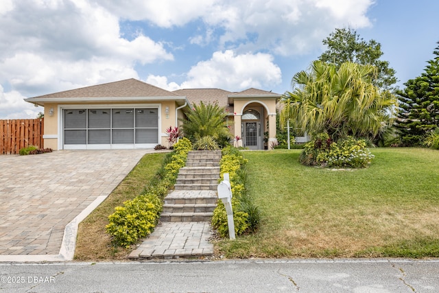 view of front of house with a garage and a front yard