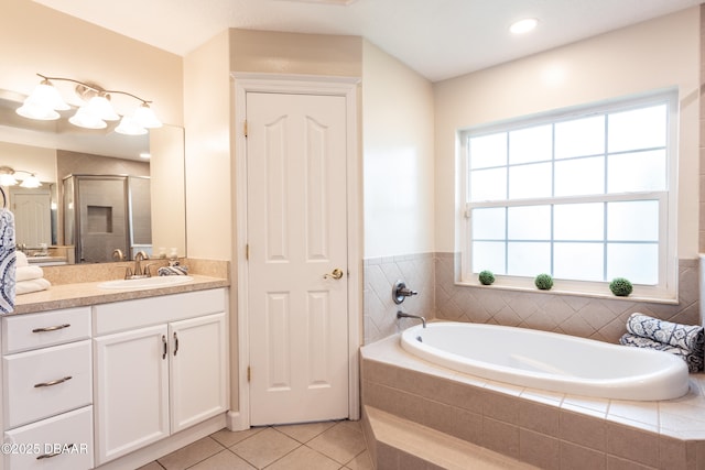 bathroom with tile patterned floors, independent shower and bath, and vanity