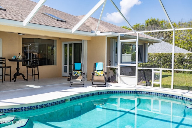 view of swimming pool featuring an outdoor bar, glass enclosure, and a patio area