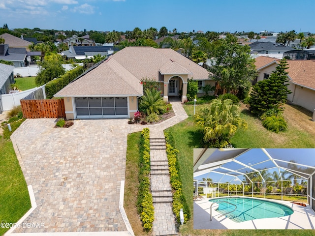 view of front of property featuring a garage and glass enclosure