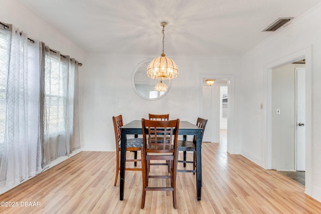 dining room with an inviting chandelier and light wood-type flooring