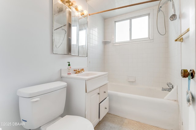 full bathroom featuring vanity, tiled shower / bath combo, and toilet