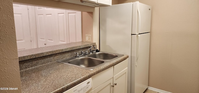 kitchen featuring white refrigerator and sink