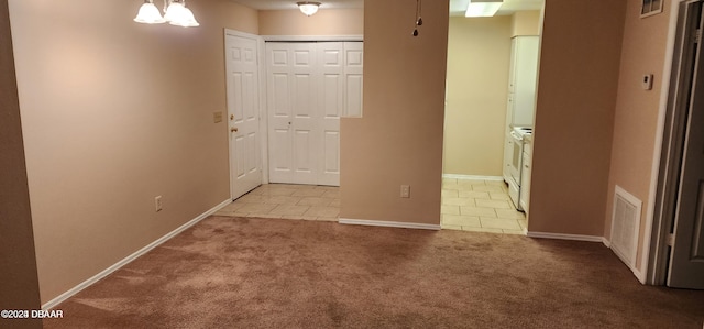 hallway featuring light carpet