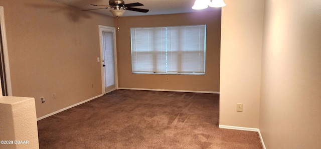 carpeted spare room with ceiling fan