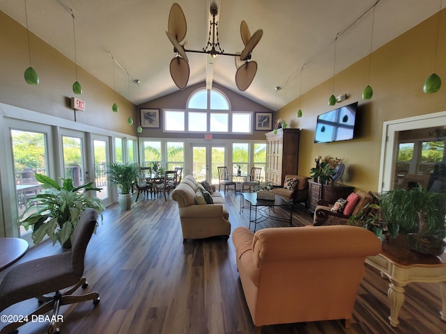 living room featuring dark hardwood / wood-style floors, an inviting chandelier, high vaulted ceiling, and french doors