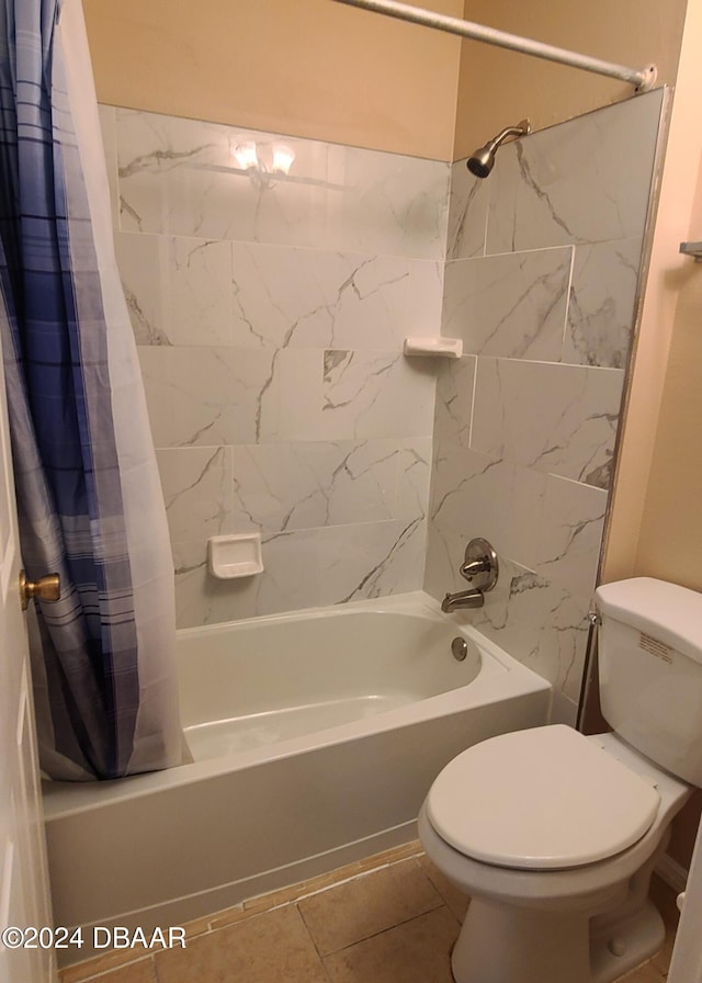 bathroom featuring tile patterned flooring, toilet, and shower / tub combo with curtain