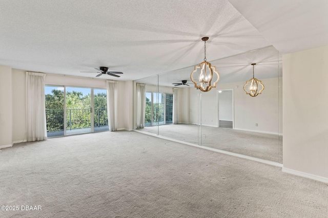 4 Oceans W Blvd Unit 306B, Daytona Beach, FL 32118 - carpeted spare room featuring a chandelier, ceiling fan, a textured ceiling, and baseboards