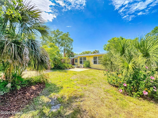 46 Reynolds Ave, Ormond Beach, FL 32174 - view of green lawn featuring a patio area