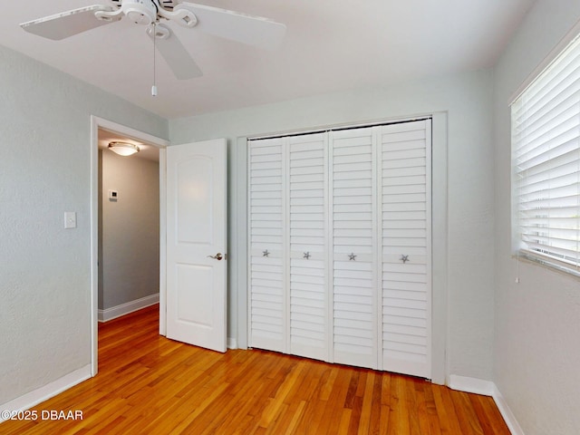 46 Reynolds Ave, Ormond Beach, FL 32174 - unfurnished bedroom featuring light wood finished floors, baseboards, a closet, and ceiling fan
