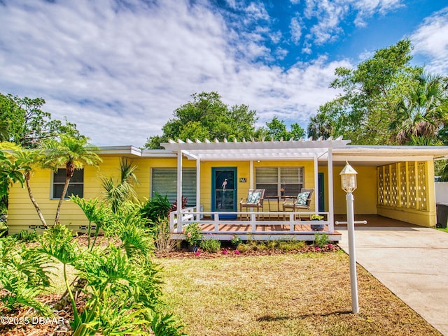 46 Reynolds Ave, Ormond Beach, FL 32174 - ranch-style home featuring a carport, concrete driveway, and a pergola