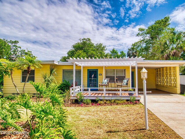 46 Reynolds Ave, Ormond Beach, FL 32174 - ranch-style home featuring an attached carport, concrete driveway, and a pergola