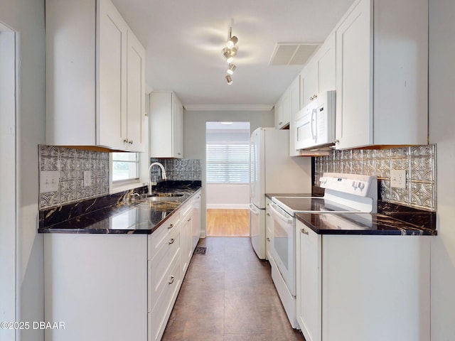 46 Reynolds Ave, Ormond Beach, FL 32174 - kitchen with white appliances, a sink, plenty of natural light, and white cabinets