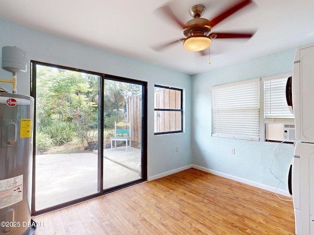 46 Reynolds Ave, Ormond Beach, FL 32174 - entryway featuring stacked washer / dryer, electric water heater, light wood-style flooring, baseboards, and ceiling fan