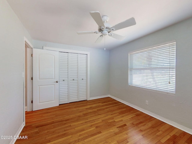 46 Reynolds Ave, Ormond Beach, FL 32174 - unfurnished bedroom with light wood-type flooring, a closet, baseboards, and a ceiling fan