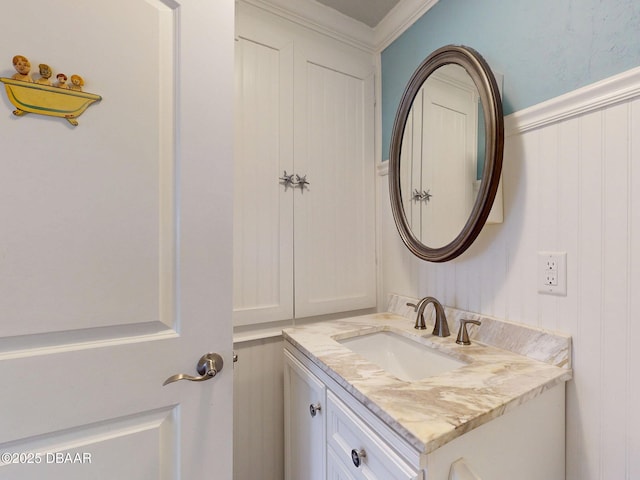 46 Reynolds Ave, Ormond Beach, FL 32174 - bathroom with vanity, a decorative wall, and crown molding