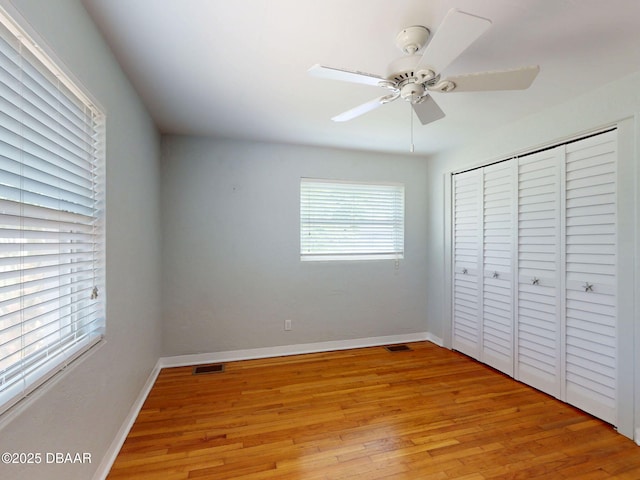 46 Reynolds Ave, Ormond Beach, FL 32174 - unfurnished bedroom featuring light wood-style floors, baseboards, a closet, and ceiling fan
