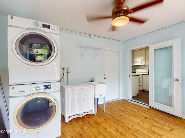 46 Reynolds Ave, Ormond Beach, FL 32174 - washroom featuring stacked washing machine and dryer, light wood-type flooring, and ceiling fan