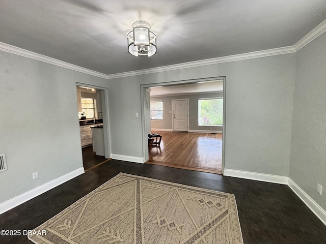 46 Reynolds Ave, Ormond Beach, FL 32174 - unfurnished dining area with ornamental molding, a chandelier, and dark wood-style flooring